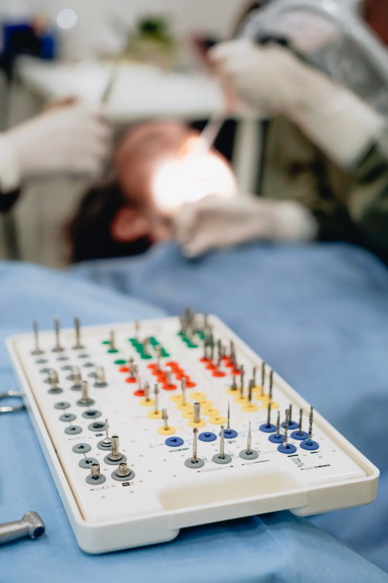 Dental implant instrument kit prepared for surgery with the specialist dentist working at chairside — how implant placement is performed at accredited Turkish clinics