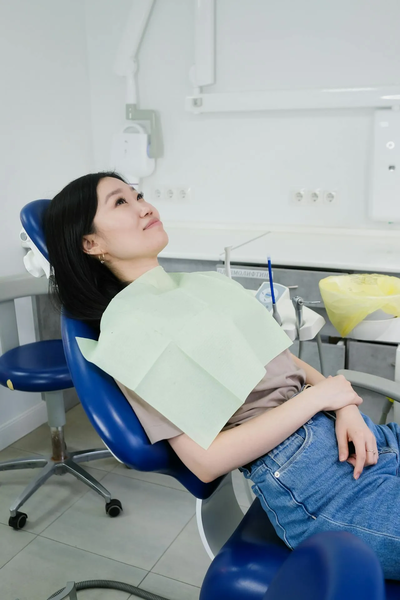 Woman relaxed and smiling in a dental chair after successful treatment completion at a Turkish dental clinic in Antalya